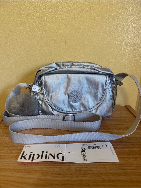 Kipling Handbags - Kipling Metallic Silver Crossbody with Pom-Pom Charm